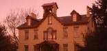 The sunrise casts a pink glow on the facade of President van Buren's home.